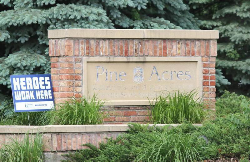 The sign at Pine Acres Rehab and Living Center in DeKalb Thursday afternoon. Nine staff members and 31 residents at the facility have tested positive for COVID-19. One resident has died as a result of complications from the disease.