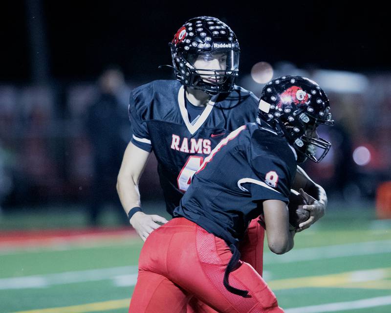 Glenbard East's Michael Nee hands the ball of to Kedrick Dennis against Batavia at the Class 7 A Second Round playoff game on Friday, Nov. 7,2025 in Lombard.