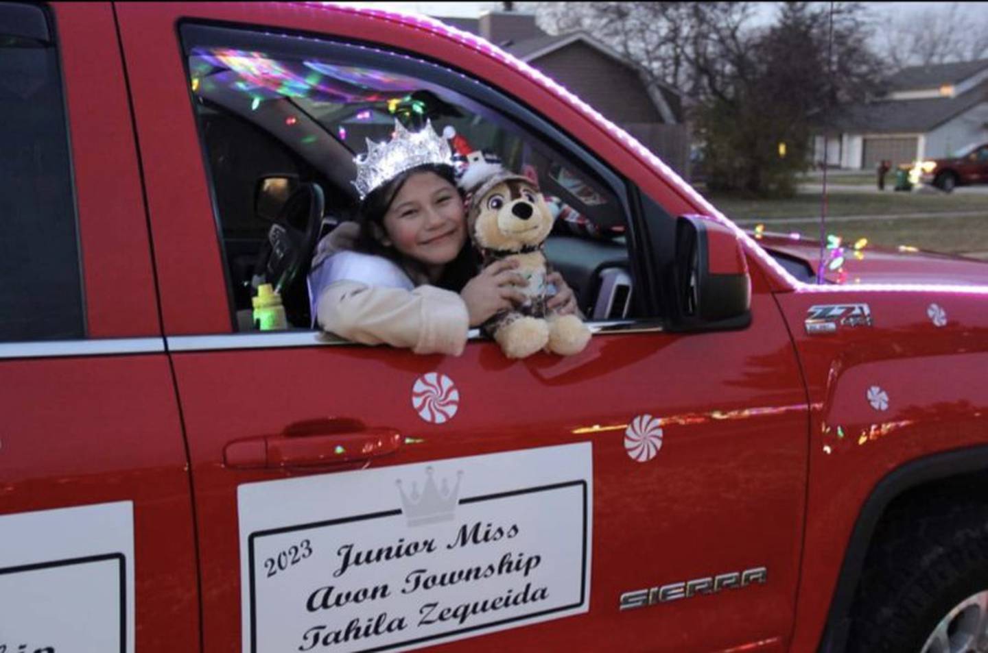 Max gets a squeeze from Junior Miss Avon Township Tahila Zequeida during a recent parade.