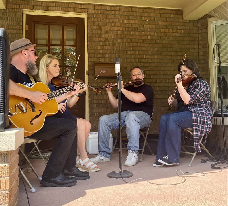 Local Irish music players perform on a Campbell St. porch at Porch & Park Music Fest 2024