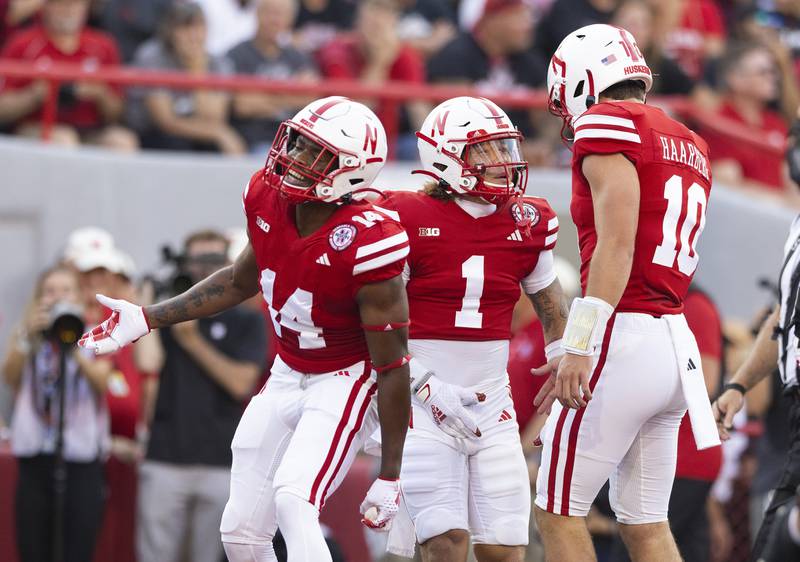 Nebraska's Billy Kemp IV (1) celebrates a touchdown with teammates Rahmir Johnson (14) and quarterback Heinrich Haarberg (10) against Northern Illinois during the first half of an NCAA college football game, Saturday, Sept. 16, 2023, in Lincoln, Neb. (AP Photo/Rebecca S. Gratz)
