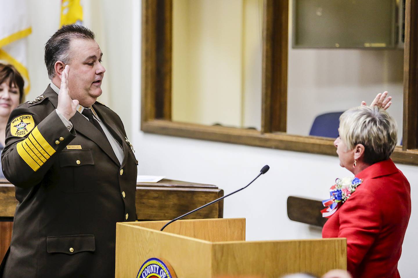 Newly elected Will County Sheriff Mike Kelley is sworn in Monday by Will County Clerk Nancy Schultz-Voots.