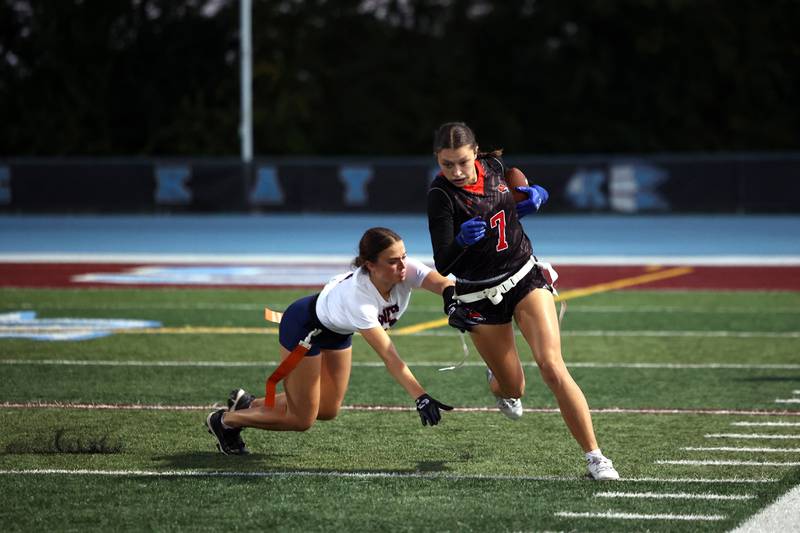 Yorkville's Teaghan Green avoids Oswego's Leona Bateman for a first down during the Foxes' 2-1 overtime victory over Oswego in the IHSA Kankakee Regional championship game on Thursday, Oct. 9, 2025.