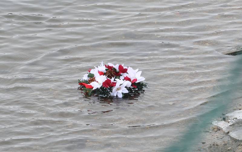 A wreath is thrown into the Illinois River during the 46th annual Peal Harbor parade and Memorial service at the South Shore Boat Club in Peru.
