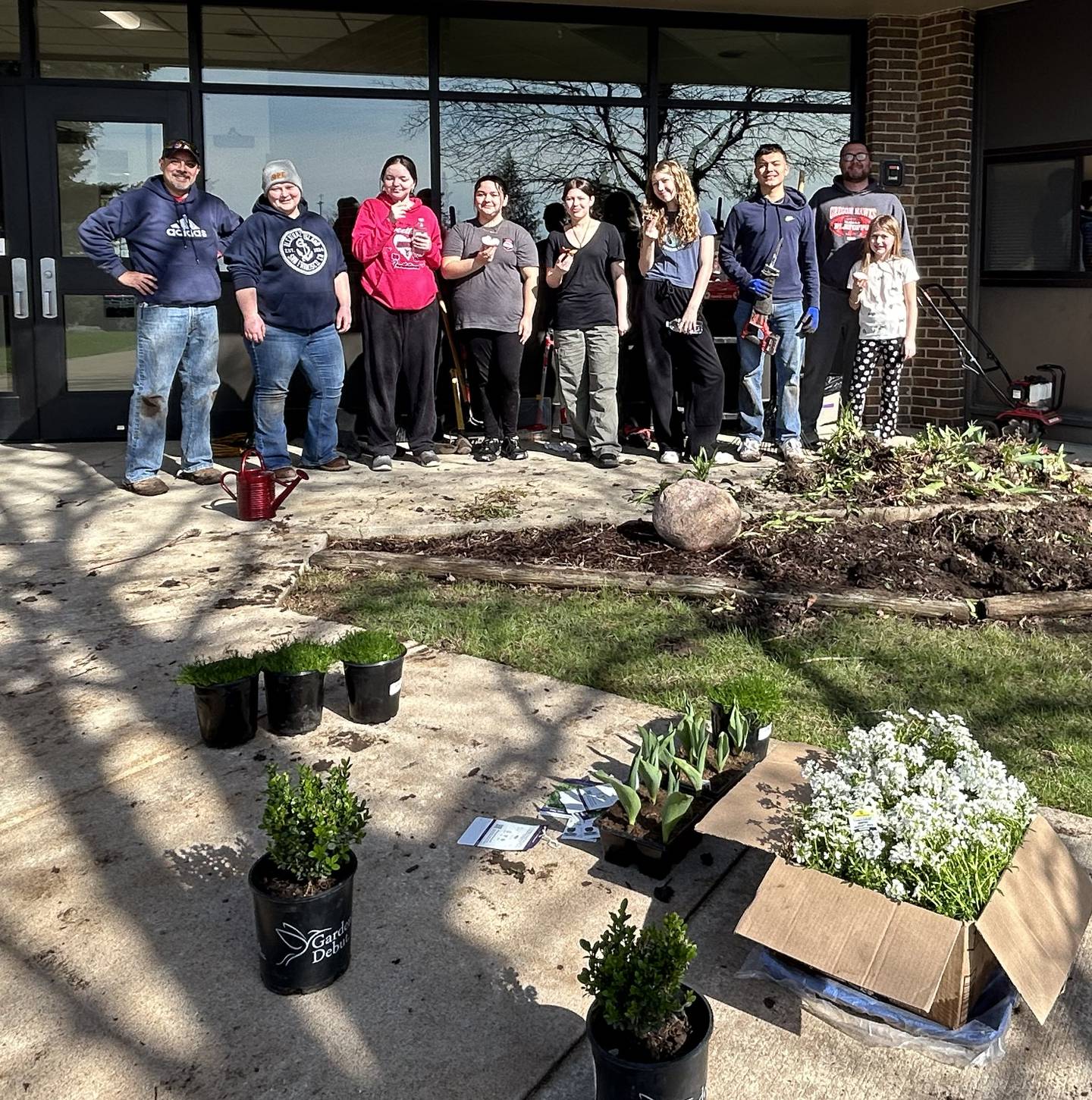 Oregon School District staff members and students worked on improving landscaping near the Etnyre gym entrance on Saturday, April 5, 2025.