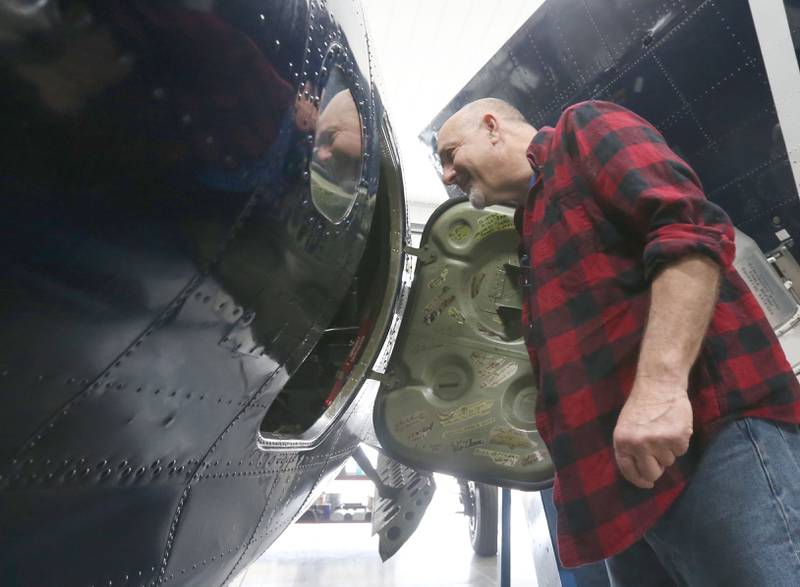 Brad Deckert opens the side door to his TBM Avenger aircraft on Tuesday, April 29, 2025 at the Illinois Valley Regional Airport in Peru. This year marks the 10th year of the annual TBM Reunion and Air Show that will take place May 16-17 at the airport. The airplane has solid evidence that it sunk a Japanese destroyer in World War II. Throughout WWII, General Motors instructed nearly 10,000 torpedo bombers. Today, only about 20 remain airworthy.