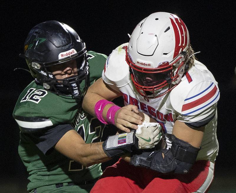 Oregon’s Logan Weems is tackled for a loss by Rock Falls’ Austin Casteneda Friday, October 11, 2024.