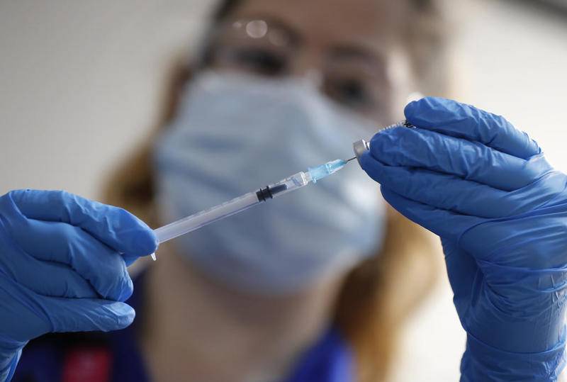 A nurse prepares a shot of the Pfizer-BioNTech COVID-19 vaccine at Guy's Hospital in London, Tuesday, Dec. 8, 2020, as the U.K. health authorities rolled out a national mass vaccination program.  U.K. regulators said Wednesday Dec. 9, 2020, that people who have a "significant history" of allergic reactions shouldn't receive the new Pfizer/BioNTech vaccine while they investigate two adverse reactions that occurred on the first day of the country's mass vaccination program. (AP Photo/Frank Augstein, Pool)