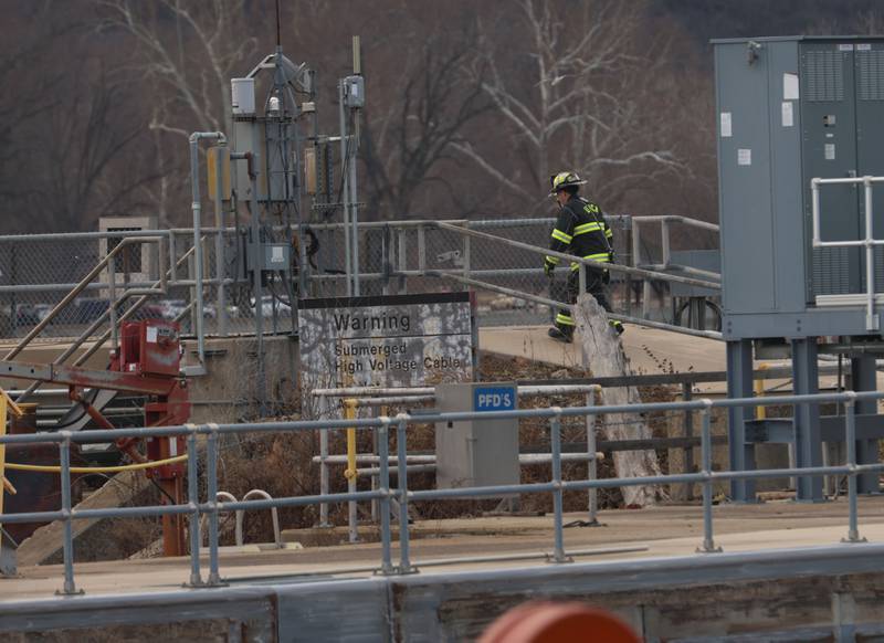 Utica fire Chief Ben Brown, walks toward the entrance to the Peru Hydroelectric Power Plant on Tuesday, Jan. 13, 2026 at the Starved Rock Lock and Dam near Utica. A light haze of smoke was coming from inside the power plant. Fire departments from Tonica, La Salle, Wallace, Tonica, Peru and Utica all responded to the scene. The incident happened shortly before 2:30p.m. No injuries were reported.