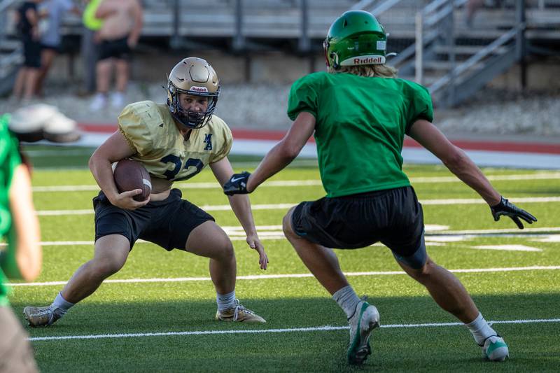 Grant Dose of Marquette attempts to dodge Mason Morscheiser of L-P during scrimmage on Tuesday July 16, 2025 at Howard Fellows Stadium in LaSalle.