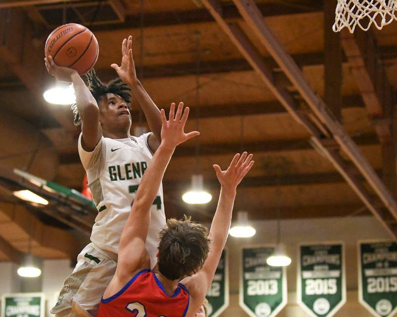 Glenbard West's TJ Williams, left, makes a shot in the second quarter while being defended by Glenbard South's Harper Bryan on Monday Nov. 20, 2023, during The district 87 Invite held at Glenbard West.