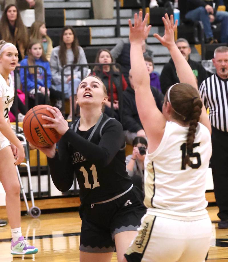 Kaneland's Berlyn Ruh goes to the basket against Sycamore's Sophia Klacik during the Class 3A regional final game Friday, Feb. 17, 2023, at Sycamore High School.