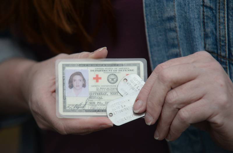 Navy Veteran, Marylee Leu with her dog tags and work ID card Saturday Oct 25, 2025.