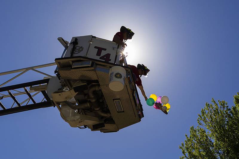 Sterling firefighters Nick Simpson (left) and Kurt Landis drop an egg space lander Friday, May 16, 2025, at Sterling’s Lincoln School. Fifth graders at the school designed and built landers to safely bring eggs down to terra firma.
