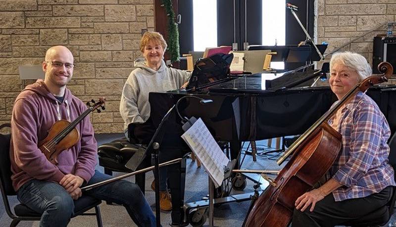 Clinton Symphony Orchestra musicians (from left) violinist Asa Church, pianist Nadia Wirschnianski, and cellost Ann Balderson prepare for the “Music of Friendships” concert at 2 p.m. Jan. 14, 2024 in Zion Lutheran Church in Clinton, Iowa.