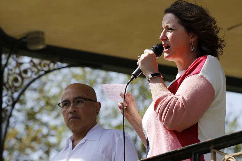 McHenry County Board members Carlos Acosta, left, and Kelli Wegener speak to a crowd of about 80 attendees at a rally to end McHenry County's contract with U.S. Immigration and Customs Enforcement on Saturday, May 1, 2021, in Woodstock.