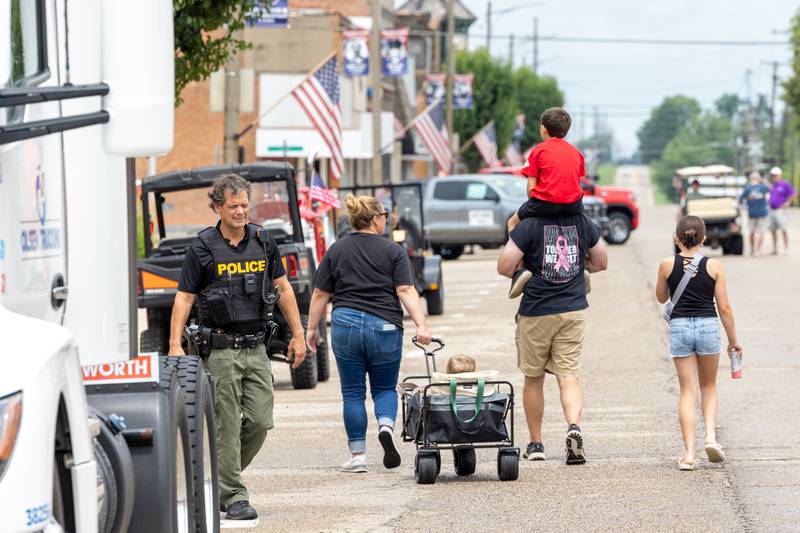 Family’s walk through the 21st annual Convoy Against Cancer on Saturday, July 19, 2025 on Main Avenue in Ladd.