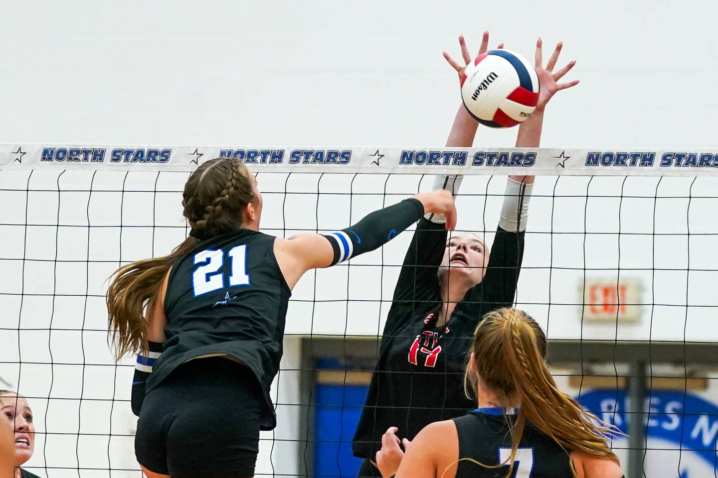 Huntley’s Lucy Watson (17) blocks a kill attempt by St. Charles North's Brynn Hopkins (21) during a non-conference match at St. Charles North High School on Wednesday, Sept. 3, 2025.