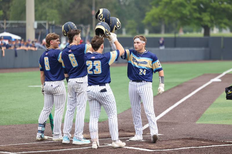 Ottawa Marquette’s Anthony Couch celebrates his home run with teammates during the Crusaders' 16-1 victory over Lexington in the IHSA Class 1A State semifinal on Friday, June 6, 2025.