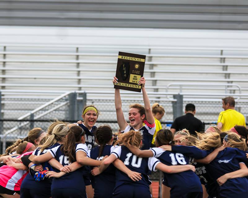 Oswego East celebrates their victory over Oswego for the Class 3A East Aurora Regional final. May 20, 2022