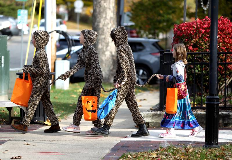 Children go trick-or-treating at Geneva businesses on Thursday, Oct. 27, 2022.