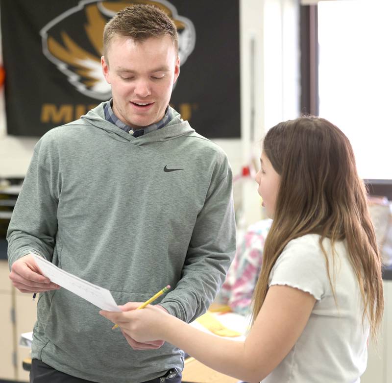 Jacob Winters, fourth grade teacher at South Prairie Elementary School, helps Izabella Griffith-Perez with a question Wednesday, April 6, 2023, at the school in Sycamore.
