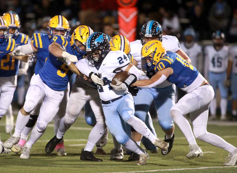 Downers Grove South’s Joseph Vieyra (center) holds onto the ball during the Class 8A second-round game against on Friday, Nov. 8, 2024 at Lyons Township in Western Springs.