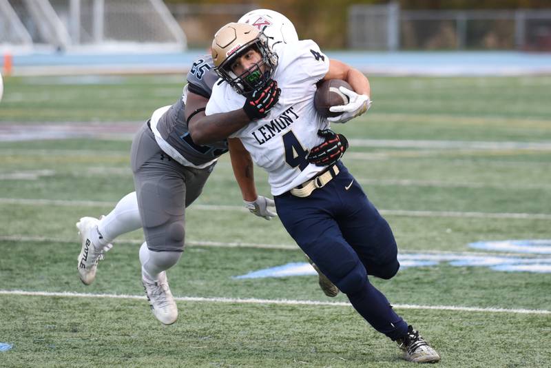 Lemont's Aiden Rudman (4) runs through a tackle attempt from Kankakee's Amari Davis during an IHSA Class 5A playoff game at Kankakee Saturday, Nov. 1, 2025.