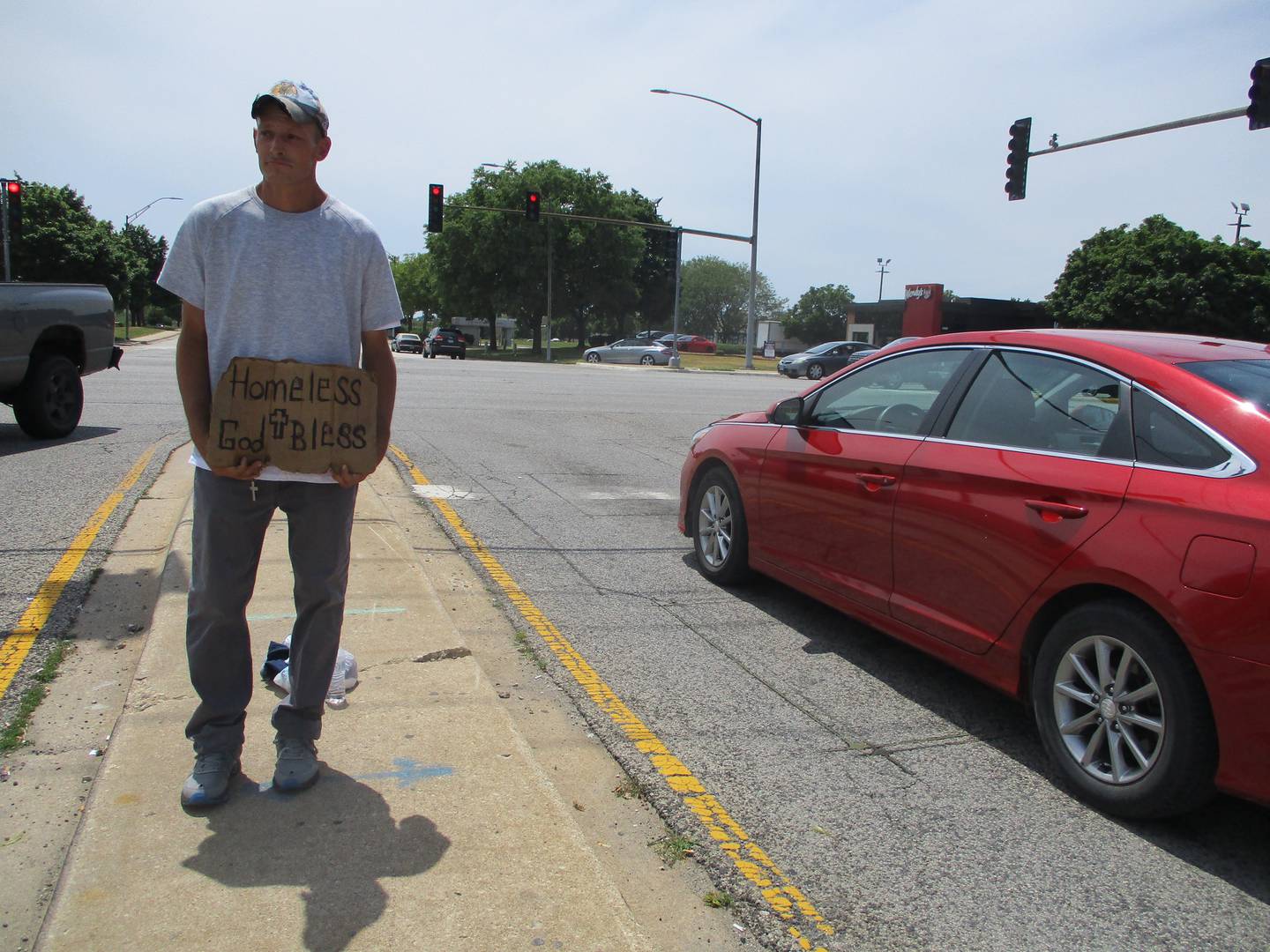 Ray Smith, seen seeking money on Voyager Lane outside a McDonald's on July 2, 2022, said Joliet police have been keeping panhandlers out of the roadway in that area long before the Fourth of July weekend.