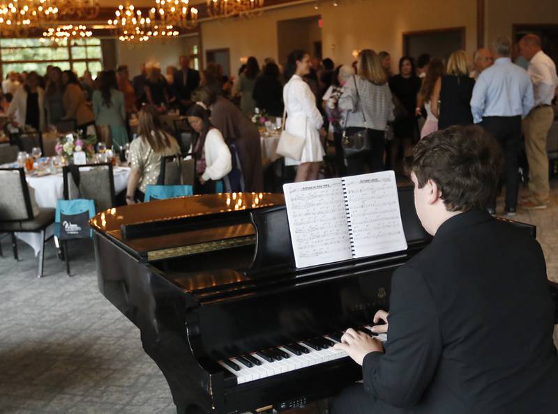 Zachary Mjaanes plays the piano during the Northwest Herald's Women of Distinction award luncheon Wednesday June 4, 2025, at Boulder Ridge Country Club, in Lake in the Hills. The luncheon recognized ten women in the community as Women of Distinction.