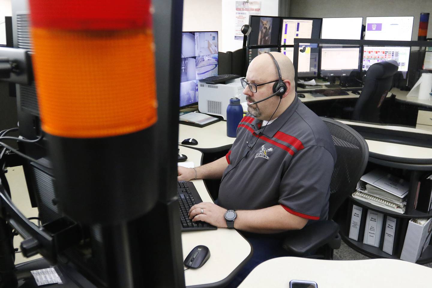 SEECOM telecommunicator Matt Gruenwald works the phones and computer systems that connect 911 calls to first responders on Wednesday, Dec. 22, 2021, at Aaron T. Shepley City Hall in Crystal Lake.