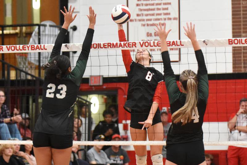 Bradley-Bourbonnais' Hannah Wojnowski, center, looks to place a hit between Bishop McNamara's Journey Slone, left, and Kate Dole during All-City action at Bradley-Bourbonnais Wednesday, Sept. 10, 2025.