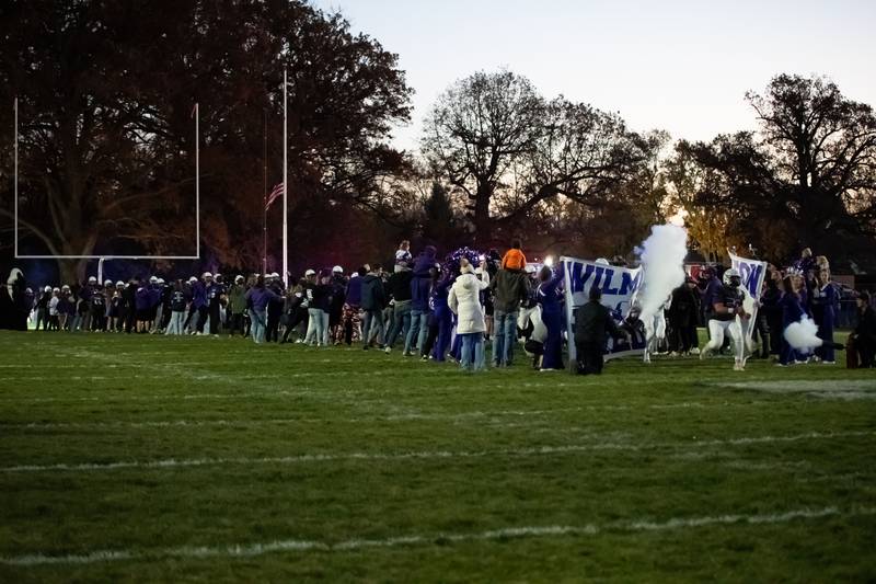 Wilmington players run out of the notorious pre-game tunnel ahead of the Wildcats’ 49-7 victory over Tri-Valley in the quarterfinal game on Saturday, Nov. 15, 2025.