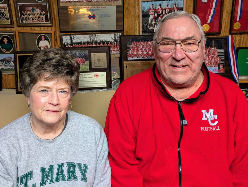 Former longtime Marian Central assistant football coach Terry Stanger and his wife, Kathy, pose for a picture in the basement of their Woodstock home Wednesday, Jan. 22, 2025. Stanger recently learned he will be inducted into the Illinois High School Football Coaches Association Hall of Fame.