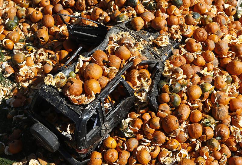 Pumpkins tossed from a 50-foot observation tower cover a vehicle on Monday, Oct. 10, 2022, at Richardson Adventure Farm, 909 English Prairie Road in Spring Grove. The farm's main attraction is a James Bond-themed corn maze, but it also features train rides, a carousel, picnic areas, wagon rides, a zip line, 150- and 100-foot slides, zorbing, a petting zoo, pumpkin patch, goat feeding area, pedal kart tracks, live music on weekends, a kid's play area, jumping pillows, pig races, air cannons, a paintball shooting gallery, indoor restrooms, gift shop and wine tasting bar.
