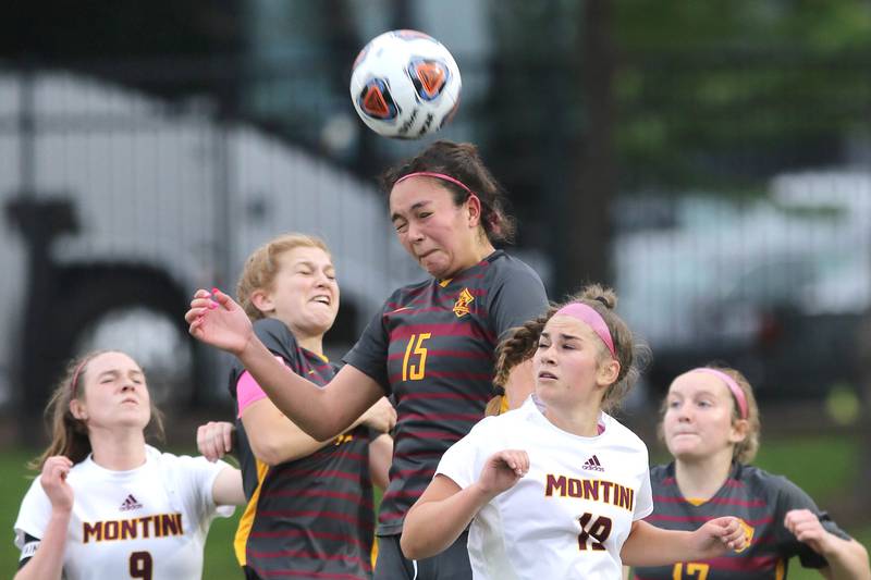 Richmond-Burton's Brianna Maldonado (left) heads the ball over Montini's Avery Lucatorto Friday, May 27, 2022, during their IHSA Class 1A state semifinal game at North Central College in Naperville.