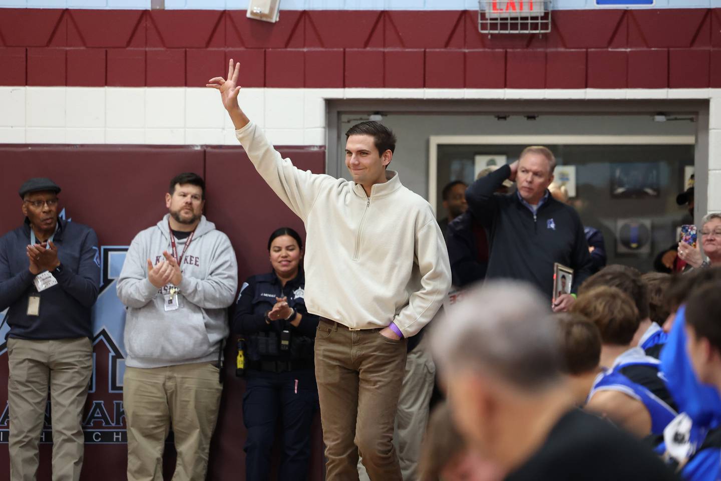 Michael Hoekstra enters the gym as he is honored as part of the All-75th Anniversary Team on the opening night of the 75th Kankakee Holiday Tournament on Friday, Dec. 26, 2025