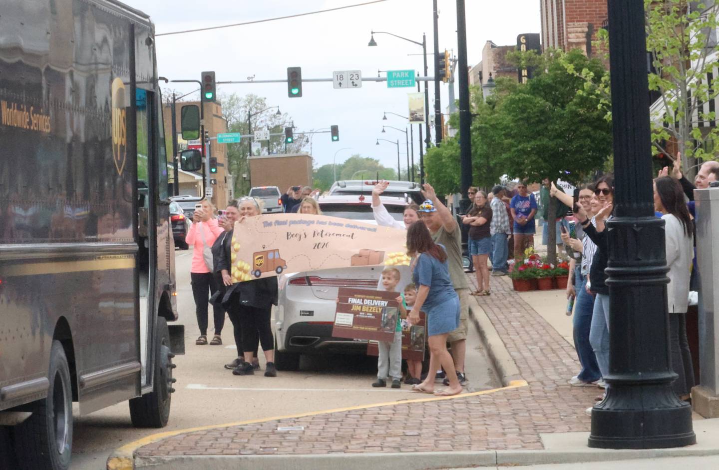 Supporters hold baners and signs while waving to UPS driver Jim Bezley, during his final delivery route on Friday, April 24, 2026 down Main Street in Streator. Bezley is retiring from UPS after 47 years. Bezley began working for UPS right out of high school in 1979.