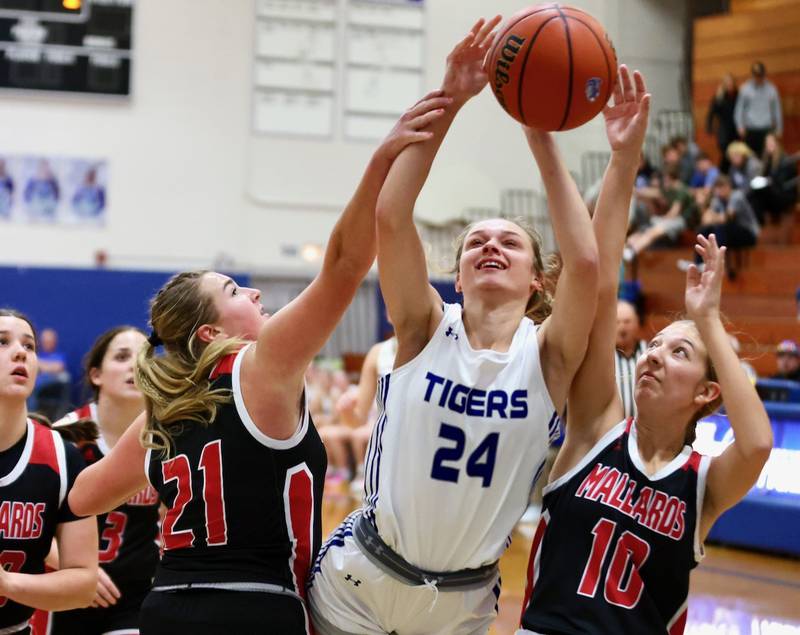 Princeton's Keighley Davis battles Henry's Brooklyn Thompson (21) and Rachel Eckert (10) Tuesday night at Prouty Gym.