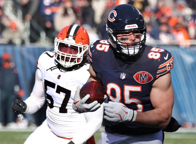 Chicago Bears tight end Cole Kmet runs ahead of Cleveland Browns defensive end Isaiah McGuire during their game Sunday, Dec. 14, 2025, at Soldier Field in Chicago.