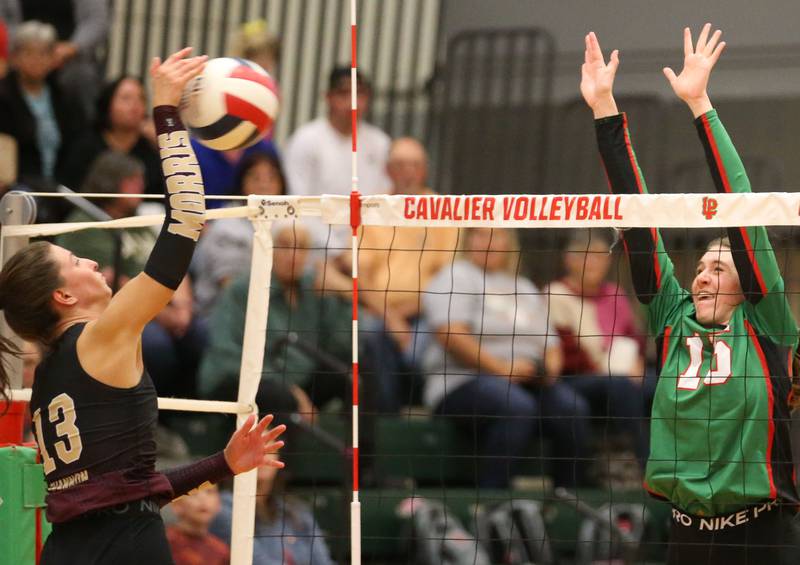 Morris's Tessa Shannon sends a kill past L-P's Drew Depenbrock on Thursday, Oct. 10, 2024 in A.J. Sellett Gymnasium at L-P High School.