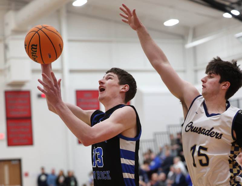 Hinckley-Big Rock's Jacob Orin gets to the basket in front of Marquette's Alec Novotney Tuesday, March 3, 2026, during their sectional semifinal matchup at Amboy High School.