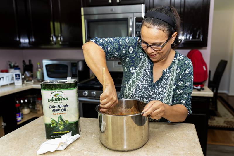 Aicha Kaltsos, who has utilized Northern Illinois Food Bank’s Project DASH program, makes dinner for her family in Joliet on Sept. 17, 2025.
