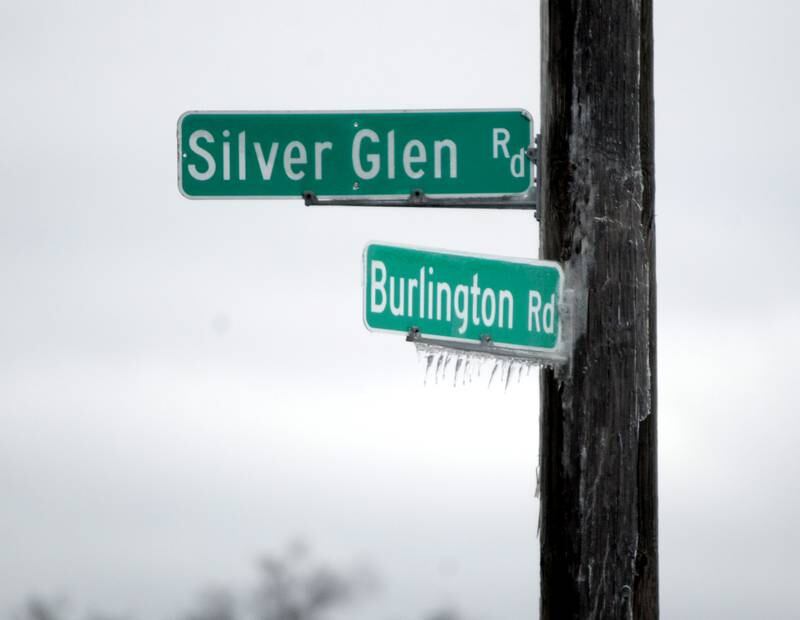 Ice covered trees and dripped from signs in western Kane County after a storm on Thursday, Feb. 23, 2023.