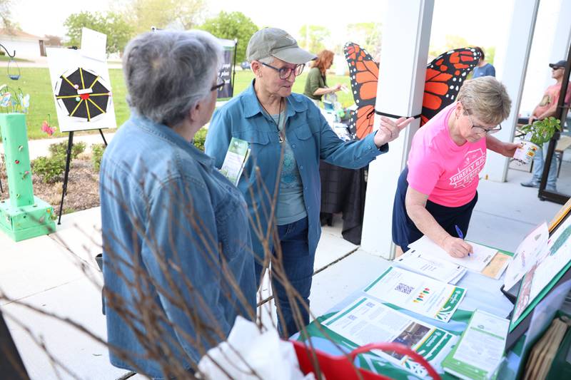 Rita Renwick, a member of the City of Joliet Tree Advisory Board, educates a resident on the variety of trees in Will County at the Green Escape Earth Day Event on Wednesday, April 22, 2026 in Joliet.