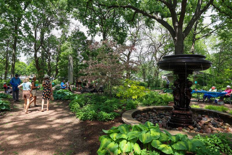 Attendees stroll through the Column Garden as the Kankakee Valley Symphony Orchestra Brass Quintet performs during the 36th annual Rhubarb Festival at the Kankakee County Museum on Sunday, May 17, 2026.