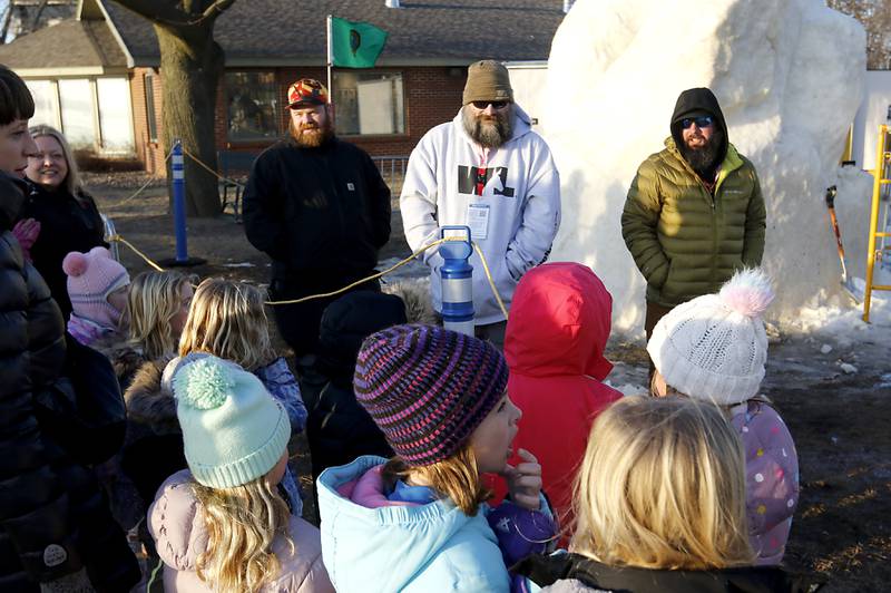 Snow carvers Jesse Melloor, Matthew Lloyd, and Richard Tiffany from the team from Washington, talk to a group of Girl Scouts on Thursday, Jan. 30, 2025, while taking a break from carving their snow sculpture for America’s Snow Sculpting Invitational during Winterfest in Lake Geneva. Winterfest, runs through Feb, 2, 2025. The warm and rainy weather has slowed down the carving of the snow.