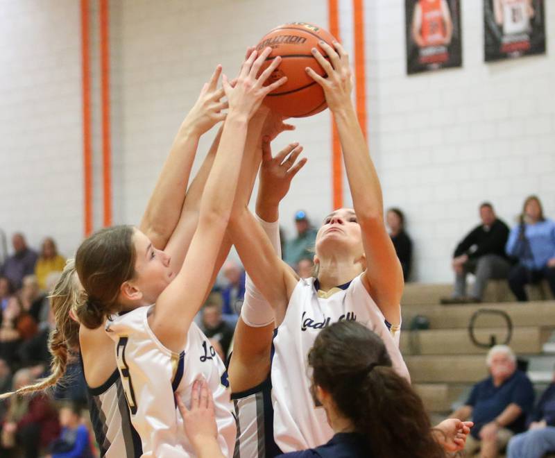 Marquette's Morgan Nelson and teammate Avery Durdan grab a rebound over Fieldcrest during the Integrated Seed Lady falcon Basketball Classic tournament on Monday, Nov. 13, 2023 at Flanagan High School.