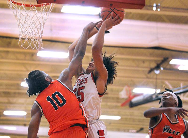 Yorkville's LeBaron Lee (35) takes a hard foul by Romeoville defender Aaron Brown (10) during a boys' basketball game at Yorkville High School on Tuesday, Jan. 10, 2023.