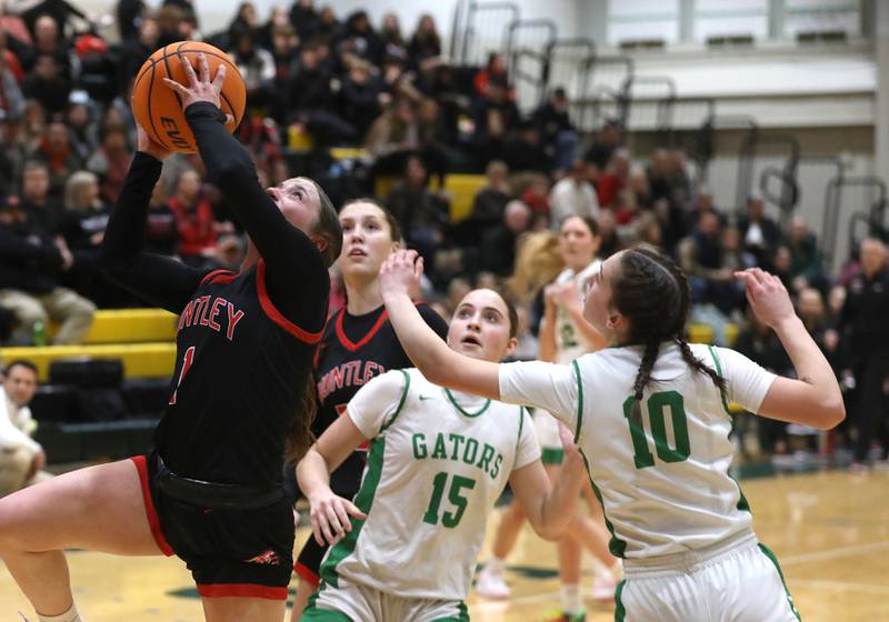 Huntley's Lana Hobday (left) drives to the basket between Crystal Lake South's Tessa Melhuish (center) and Mallory Glover (right)during a Fox Valley Conference girls basketball game on Friday, Jan. 30, 2026, at Crystal Lake South High School.